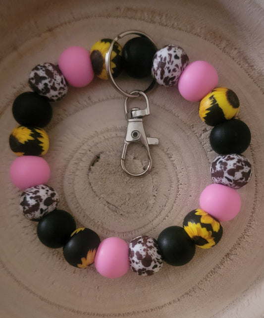 Pink sunflower cow wristlet
